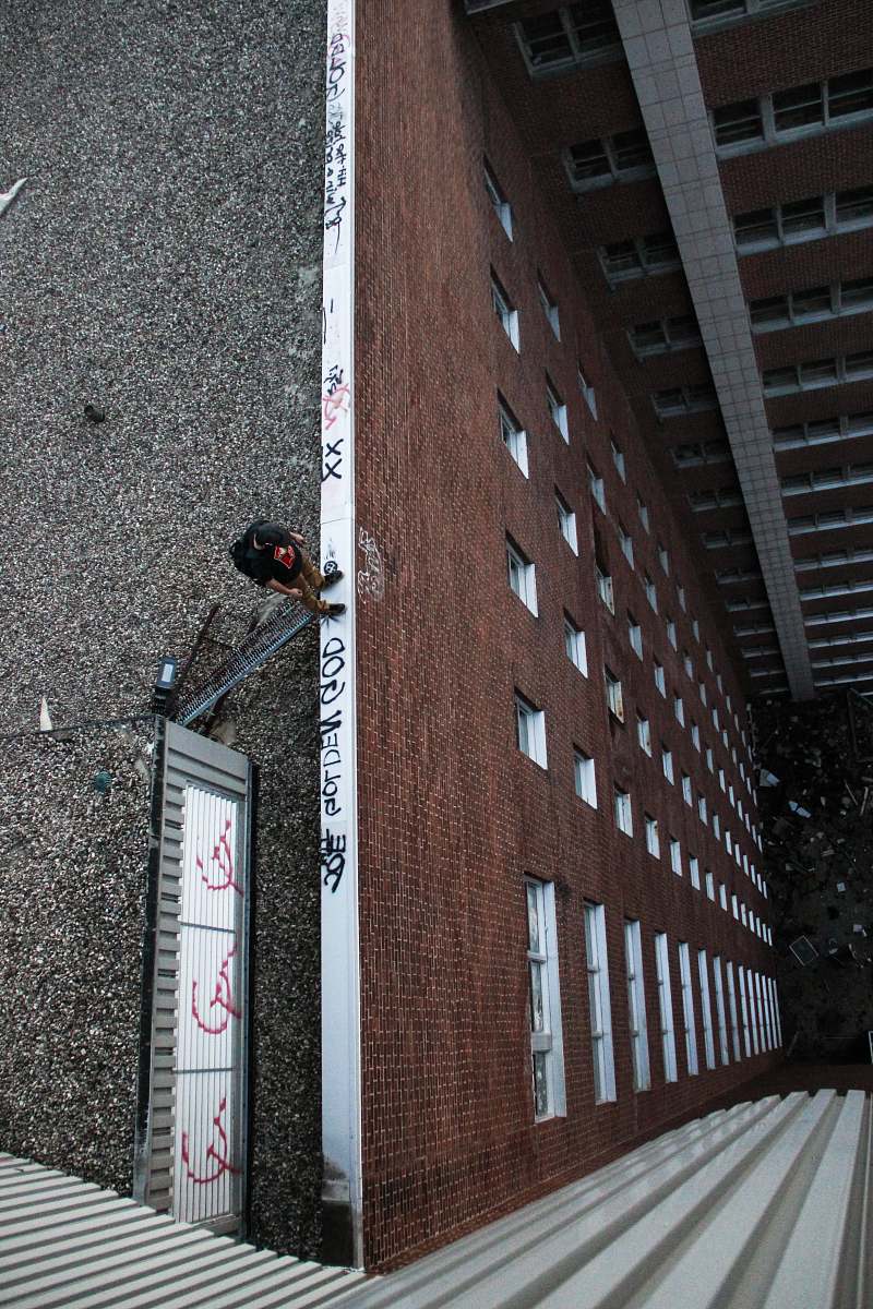 building man standing on edge on building rooftop rochester